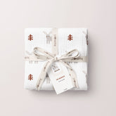 Oh Bunny muslin swaddle folded and tied with a ribbon